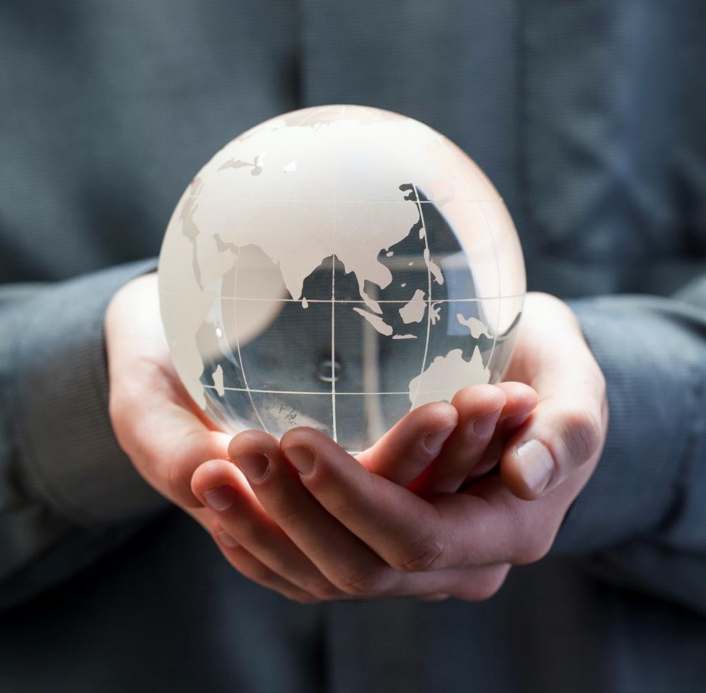 man holding a crystal ball wit earth